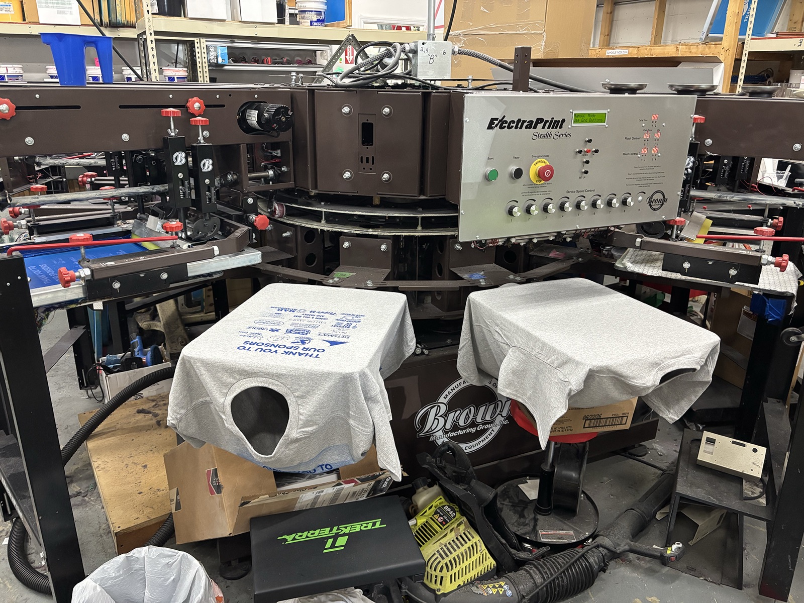 Brown automatic press for bulk T-shirt printing at CustomTees