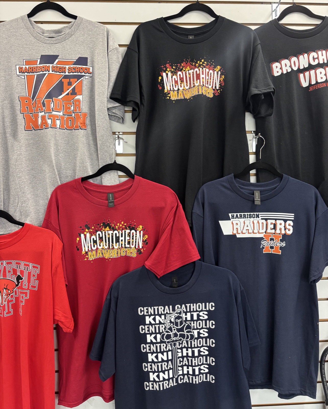 Promotional school T-shirts displayed at CustomTees